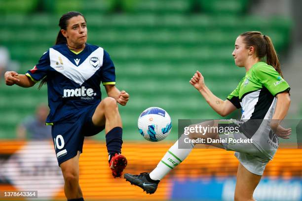 Alexandra Chidiac of Melbourne Victory and Laura Hughes of Canberra United contest the ball during the round 14 A-League Women's match between...