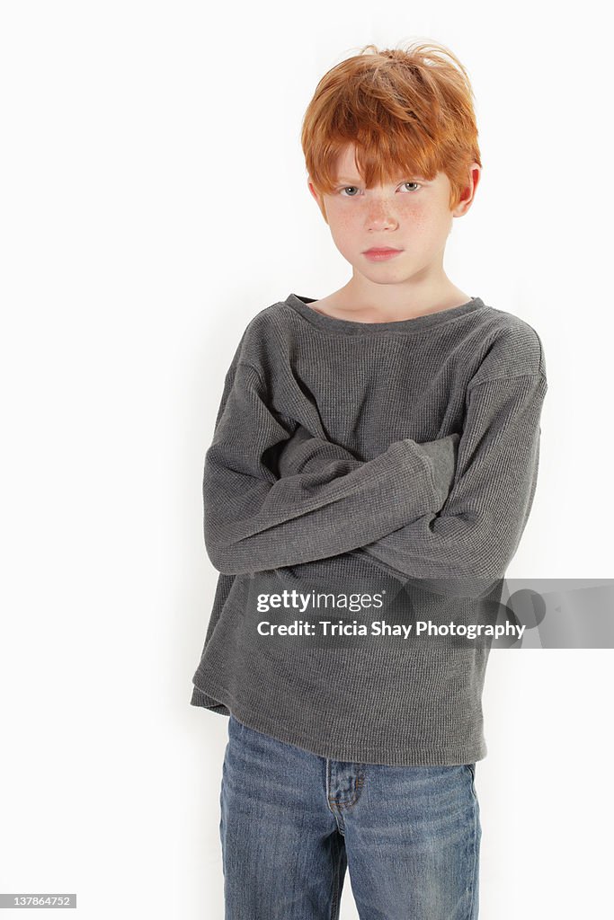 Redhead boy with arms crossed