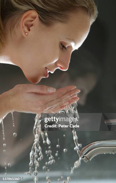 woman washing face - splash stock pictures, royalty-free photos & images