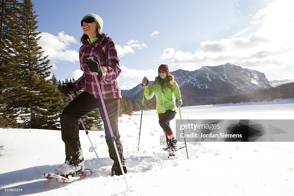 Two females snowshoeing