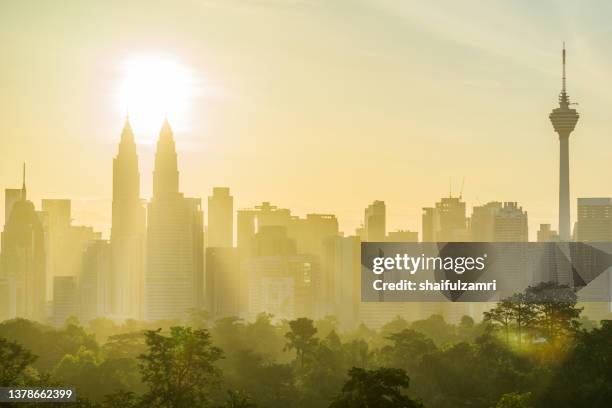 majestic sunrise over downtown kuala lumpur with petronas twin towers and kl tower still among the significant landmarks and icon for malaysia. - kuala lumpur twin tower stock pictures, royalty-free photos & images