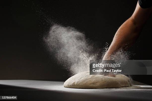 fist punching down dough - flour foto e immagini stock