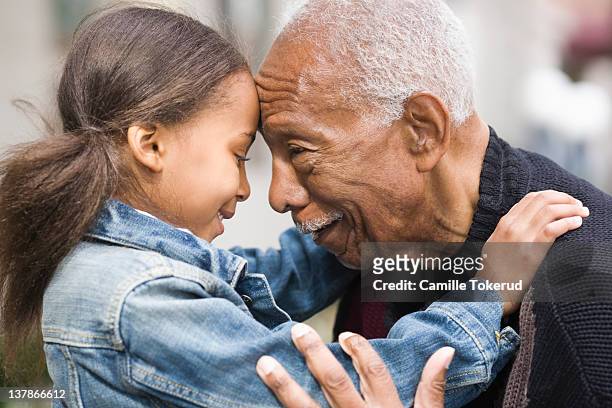 grandfather and granddaughter face to face - grandfather stock pictures, royalty-free photos & images