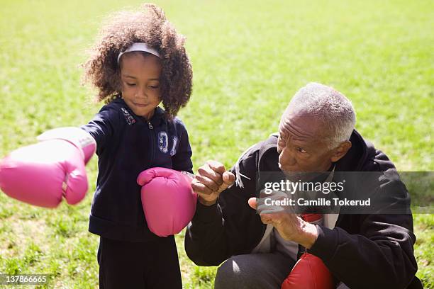 grandfather teaching grandson boxing - boxing man stock pictures, royalty-free photos & images