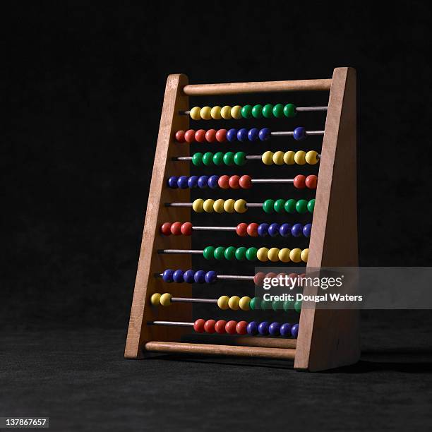 wooden abacus against black background. - abaco fotografías e imágenes de stock