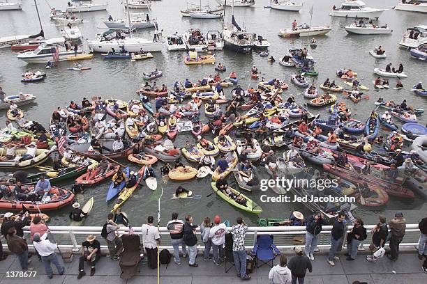 Fans wait in the San Francisco Bay outside Pac Bell Park to catch Barry Bonds' #25 of the San Francisco Giants 73rd home run during the Giants' game...