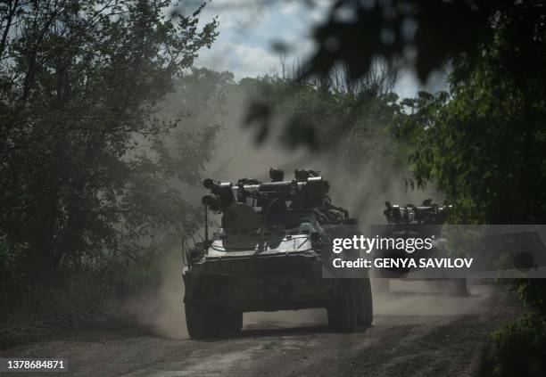 Ukrainian servicemen ride on armoured personnel carriers on a road toward Bakhmut, Donetsk region, on July 1 amid the Russian invasion of Ukraine.