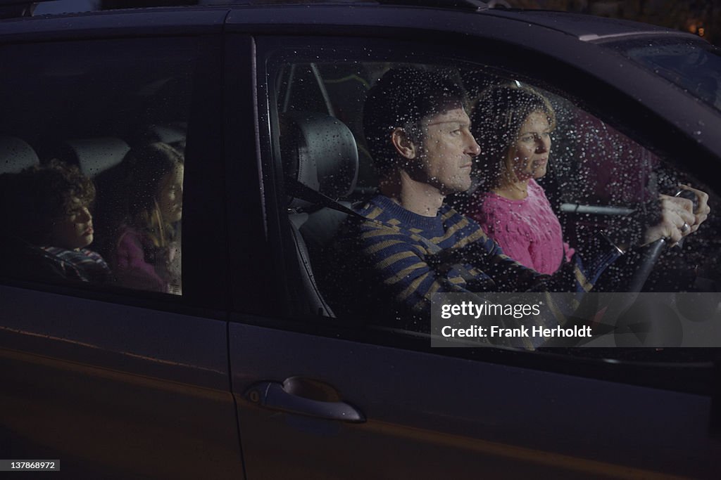 Family in car at night