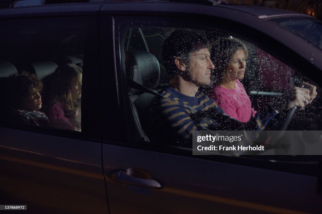 Family in car at night