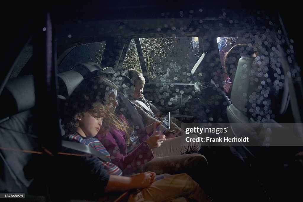 Family in car at night