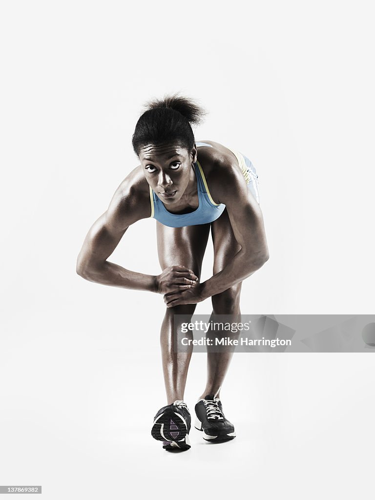 Athletic Black Female Stretching Leg Muscle