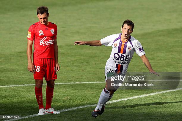 Fabian Barbiero of Adelaide reacts as Liam Millier of Perth celebrates after Miller scored a goal during the round 17 A-League match between Adelaide...