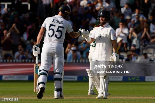 England's captain Ben Stokes congratulates England's Ben Duckett on reaching his half century on day four of the second Ashes cricket Test match...
