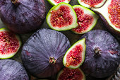 Fresh fig fruit and slices of figs, background