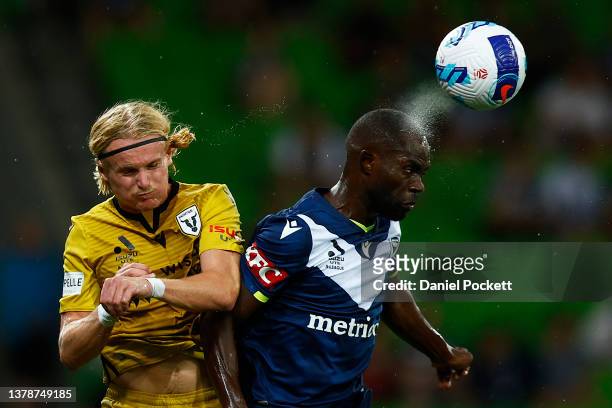 Jason Geria of the Victory heads the ball away from Lachlan Rose of the Bulls during the A-League Men's match between Melbourne Victory and Macarthur...