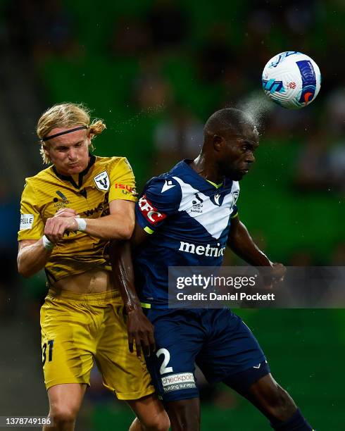 Jason Geria of the Victory heads the ball away from Lachlan Rose of the Bulls during the A-League Men's match between Melbourne Victory and Macarthur...