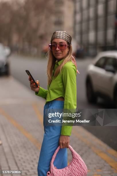 Sonia Lyson wearing Louis Vuitton pink shades, Gucci logo hair band, Miu Miu pink bag, Lumina green cropped Flanell and Lumina blue pants on March...