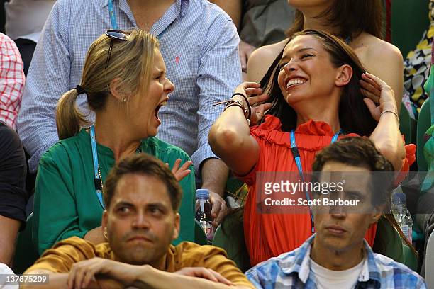 Erica Packer and her nanny laugh as they watch Novak Djokovic of Serbia and Rafael Nadal of Spain in their men's finals match during day fourteen of...