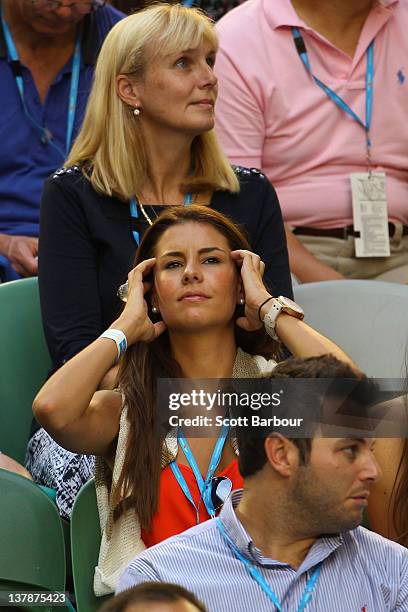 Lauren Phillips watches Novak Djokovic of Serbia and Rafael Nadal of Spain in their men's finals match during day fourteen of the 2012 Australian...