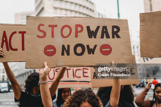 people are marching on strike against war - political rally sign stock pictures, royalty-free photos & images