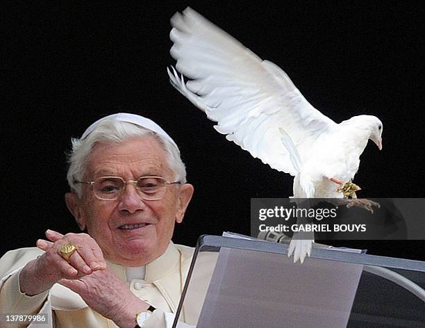 Pope Benedict XVI releases a dove from the window of his apartment at the end of his Sunday Angelus prayer in St. Peter's square at the Vatican on...