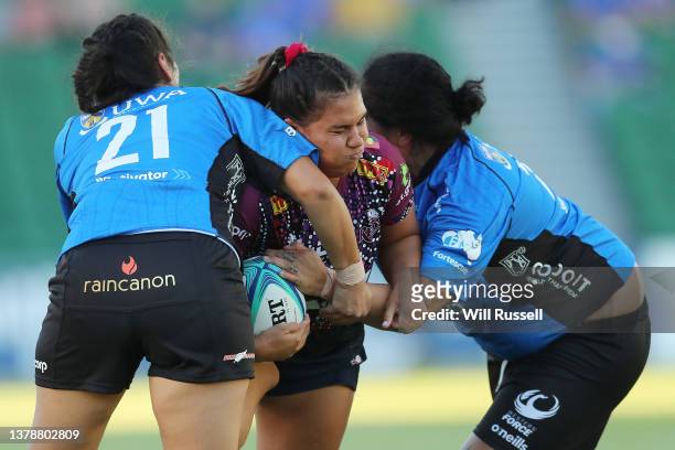 Hana Lane of the Reds is tackled by Kendra Fell and Tui Cope of the Force during the round one Super W match between Western Force and Queensland...
