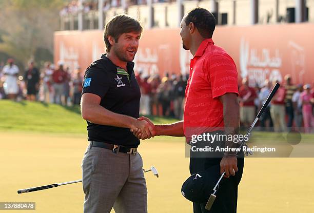 Robert Rock of England is congratulated by Tiger Woods of the USA after winning The Abu Dhabi HSBC Golf Championship at Abu Dhabi Golf Club on...