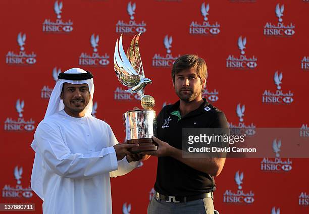 Robert Rock of England is presented with the trophy by Sheikh Sultan Bin Tahnoon Al Nahyan the Chairman of the Abu Dhabi Tourism Authority after...