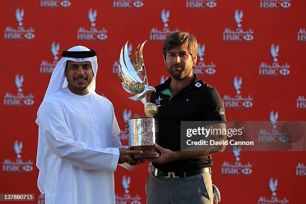 Robert Rock of England is presented with the trophy by Sheikh Sultan Bin Tahnoon Al Nahyan the Chairman of the Abu Dhabi Tourism Authority after...