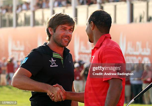 Robert Rock of England is congratulated by Tiger Woods of the USA after winning The Abu Dhabi HSBC Golf Championship at Abu Dhabi Golf Club on...