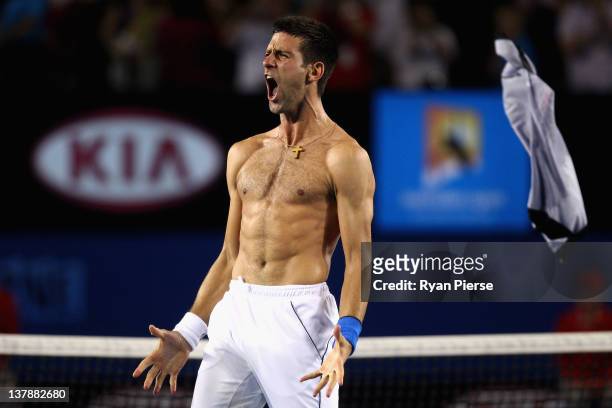 Novak Djokovic of Serbia celebrates winning championship point in his men's final match against Rafael Nadal of Spain during day fourteen of the 2012...