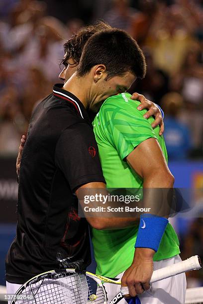 Novak Djokovic of Serbia hugs Raphael Nadal of Spain after his men's final match against Rafael Nadal of Spain during day fourteen of the 2012...