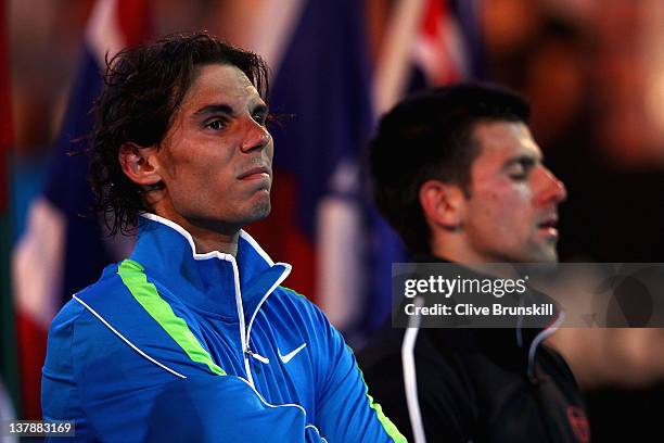 Rafael Nadal of Spain and Novak Djokovic of Serbia listen during the presentation ceremony after Djokovic won the men's final match against during...