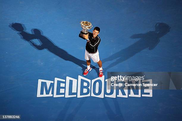 Novak Djokovic of Serbia poses with the Norman Brookes Challenge Cup after winning the men's final match against Rafael Nadal of Spain during day...