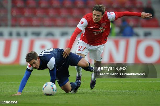 Oliver Sorg of Freiburg and Nicolai Mueller of Mainz battle for the ball during the Bundesliga match between FSV Mainz 05 and SC Freiburg at Coface...