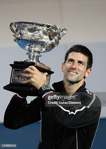 Novak Djokovic of Serbia poses with the Norman Brookes Challenge Cup after winning the men's final match against Rafael Nadal of Spain during day...