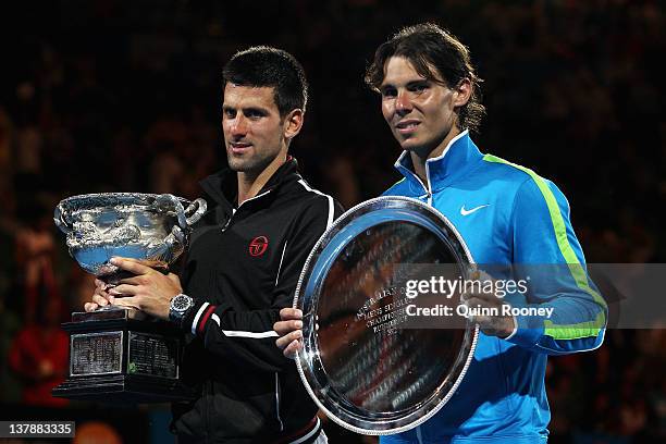 Novak Djokovic of Serbia poses with the Norman Brookes Challenge Cup alongside Raphael Nadal of Spain with the runners-up trophy after winning the...