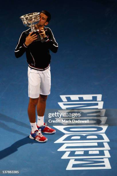 Novak Djokovic of Serbia poses with the Norman Brookes Challenge Cup after winning the men's final match against Rafael Nadal of Spain during day...