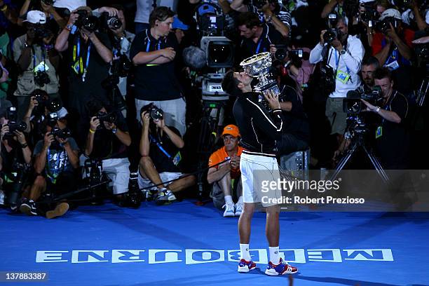 Novak Djokovic of Serbia poses with the Norman Brookes Challenge Cup after winning the men's final match against Rafael Nadal of Spain during day...