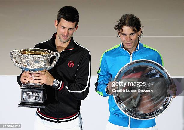 Novak Djokovic of Serbia poses with the Norman Brookes Challenge Cup alongside Raphael Nadal of Spain with the runners-up trophy after winning the...