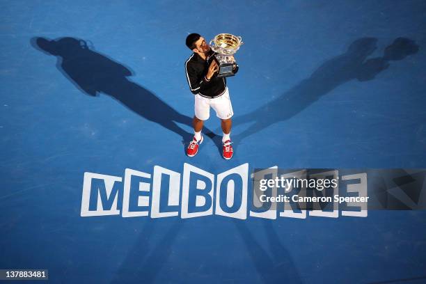 Novak Djokovic of Serbia poses with the Norman Brookes Challenge Cup after winning the men's final match against Rafael Nadal of Spain during day...