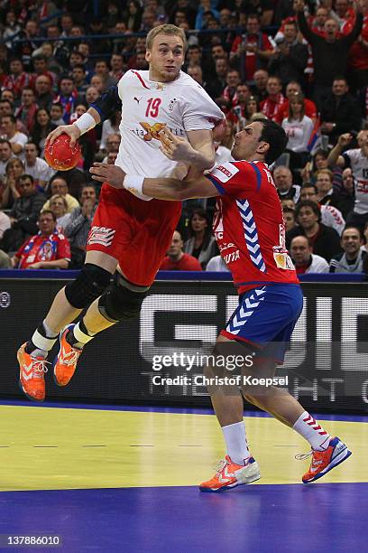 Nenad Vuckovic of Serbia defends against Rene Toft Hansen of Denmark during the Men's European Handball Championship final match between Serbia and...