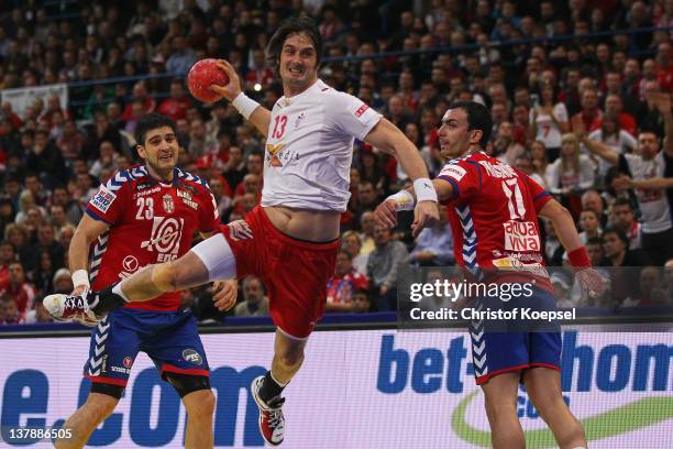 Bo Spellenberg of Denmark scores a goal against Nenad Vuckovic of Serbia and Rajko Prodanovic of Serbia during the Men's European Handball...