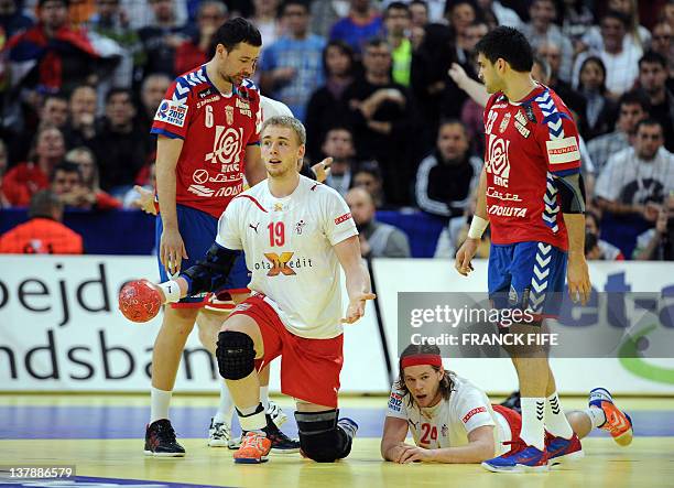 Denmark's René Toft Hansen and Mikkel Hansen gesture next to Serbia's Marko Vujin and Nenad Vuckovic during the men's EHF Euro 2012 Handball...