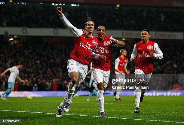 Robin van Persie of Arsenal celebrates with Theo Walcott and Alex Oxlade-Chamberlain as he scores their third goal from the penalty spot during the...