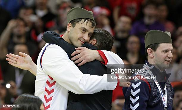 Momir Ilic of Serbia embraces an official on the podium after losing 19-21 the Men's European Handball Championship final match between Serbia and...