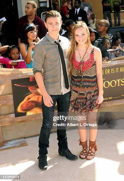 Actor Calan McAuliffe and actress Madeline Carroll attend the 'Puss In Boots' Los Angeles Premiere at Regency Village Theatre on October 23, 2011 in...