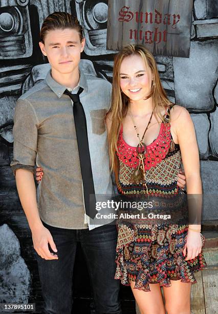 Actor Calan McAuliffe and actress Madeline Carroll attend the 'Puss In Boots' Los Angeles Premiere at Regency Village Theatre on October 23, 2011 in...