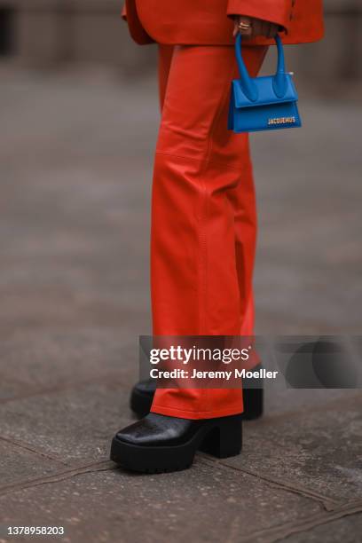 Olivia Faeh wearing Ducie London red denim two piece and Jacquemus blue mini bag before Ducie London presentation on March 02, 2022 in Paris, France.