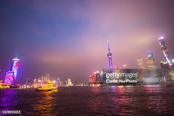 A special light show is seen along the waterfront of Bund along the Huangpu river during the Communist party founding day in Shanghai, China on July...